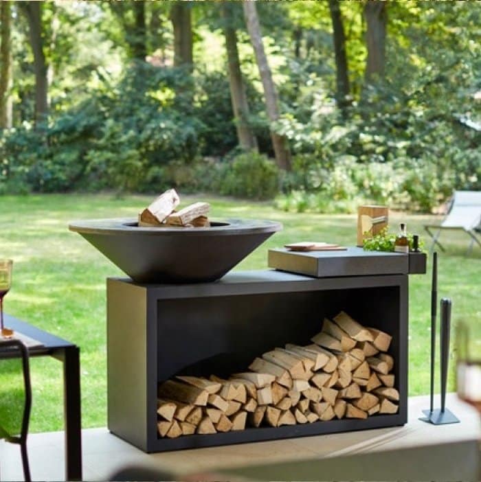 black steel bbq girll with large firewood storage