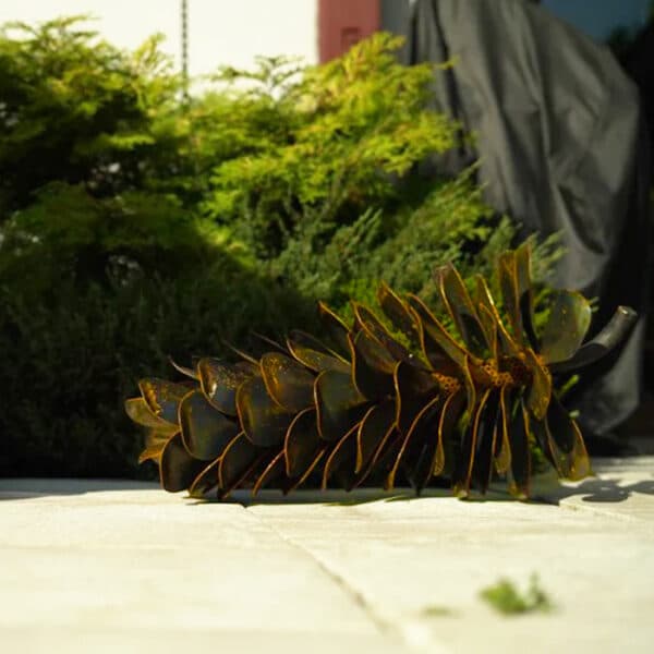 rusty metal pine cone sculpture